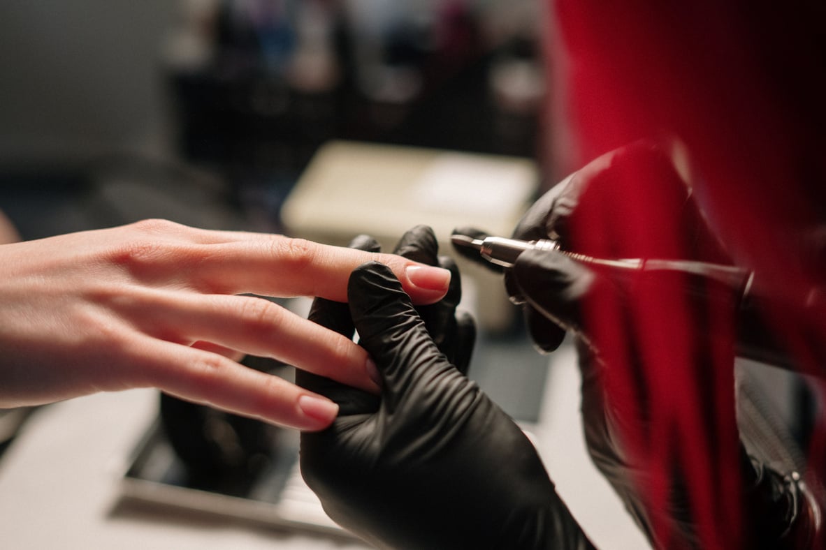 Person Wearing Silver Ring and Black Manicure